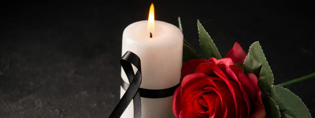 front-view-white-candle-with-red-rose-black